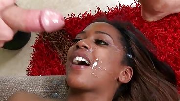 Black girl with gorgeous knockers fucks a white dude and takes a facial